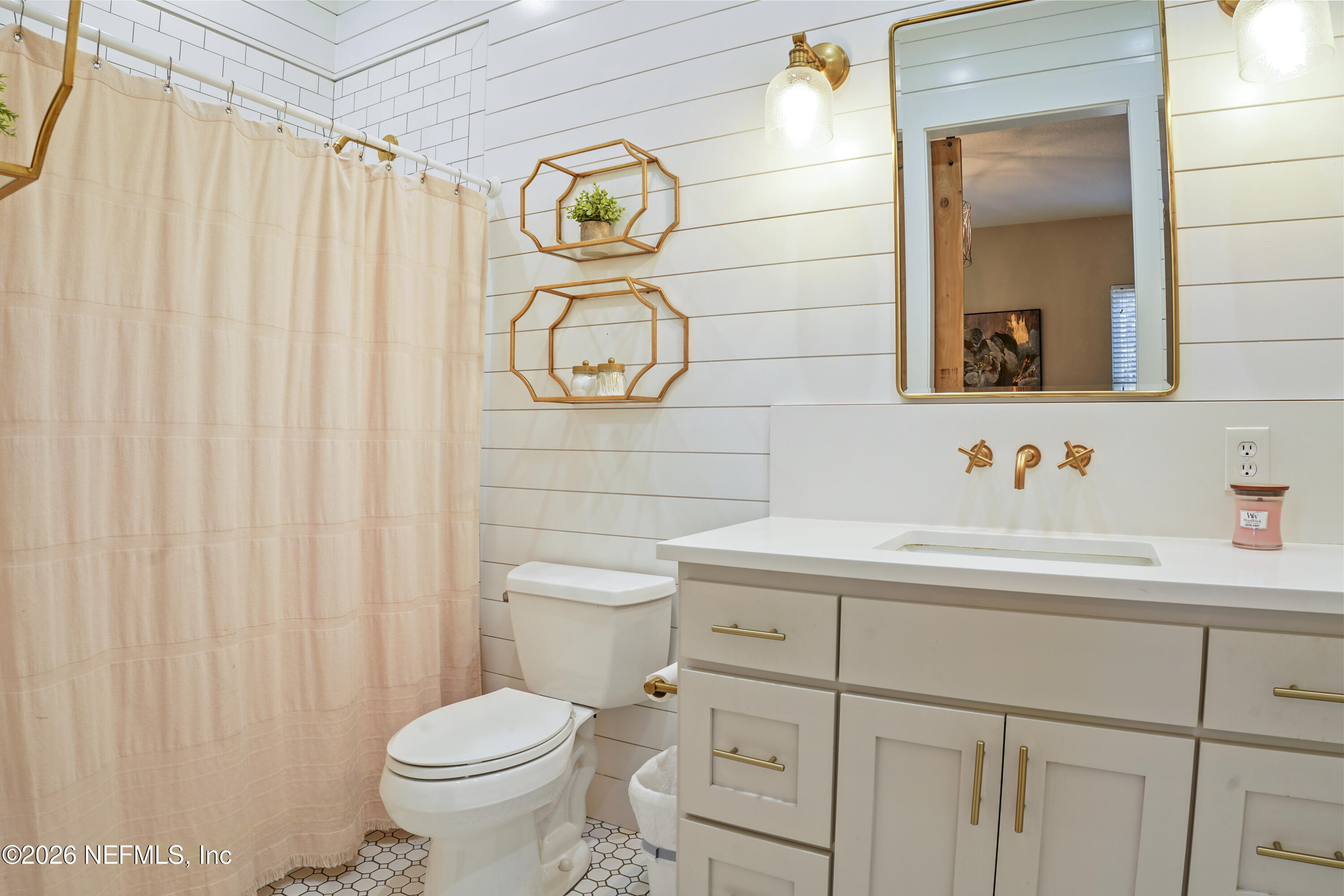 6153 Tim Crews Road Macclenny, FL 32063 - Photo 50 of 79 a bathroom with a toilet sink and mirror