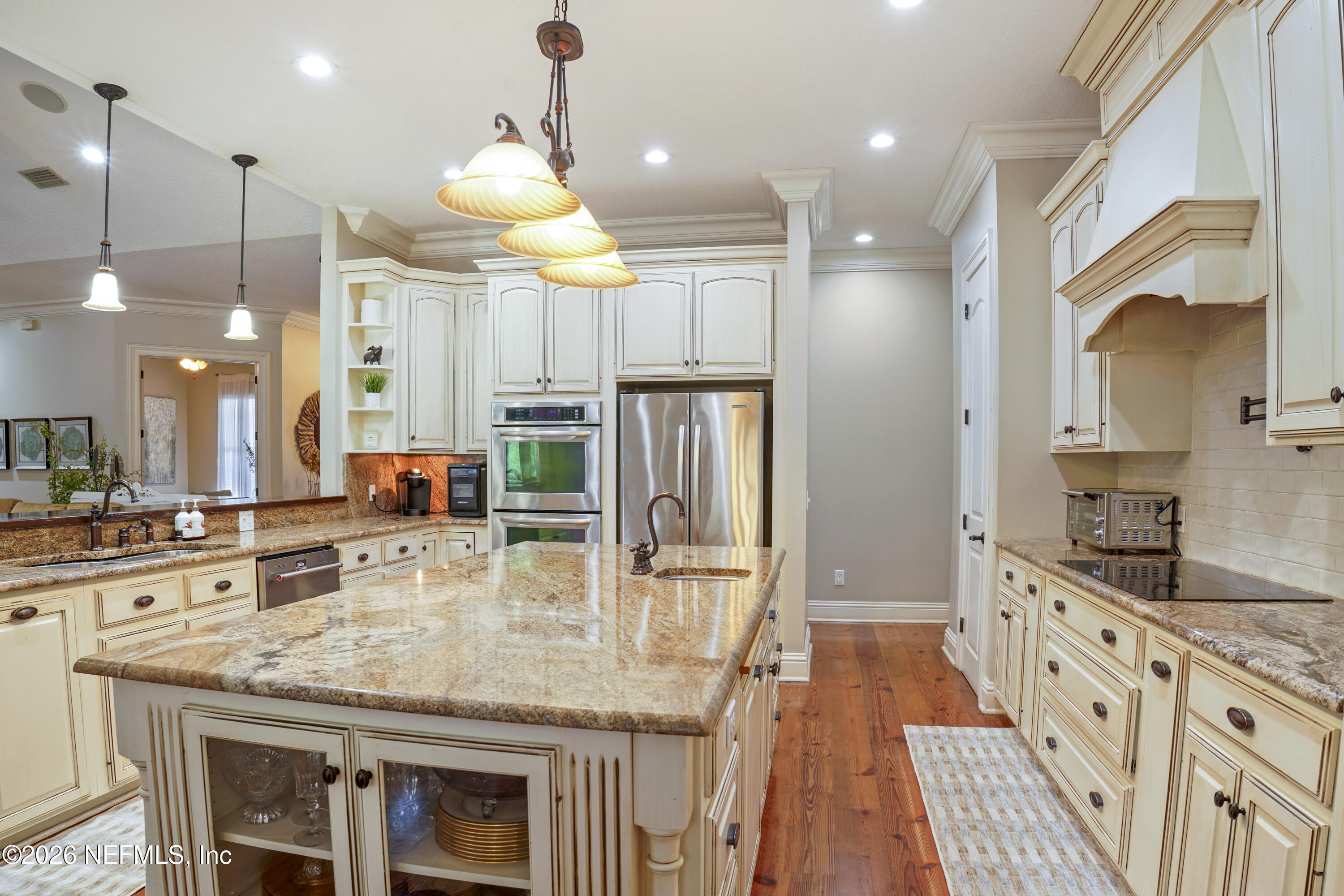 6153 Tim Crews Road Macclenny, FL 32063 - Photo 61 of 79 a kitchen with stainless steel appliances granite countertop a sink a stove and a wooden floors