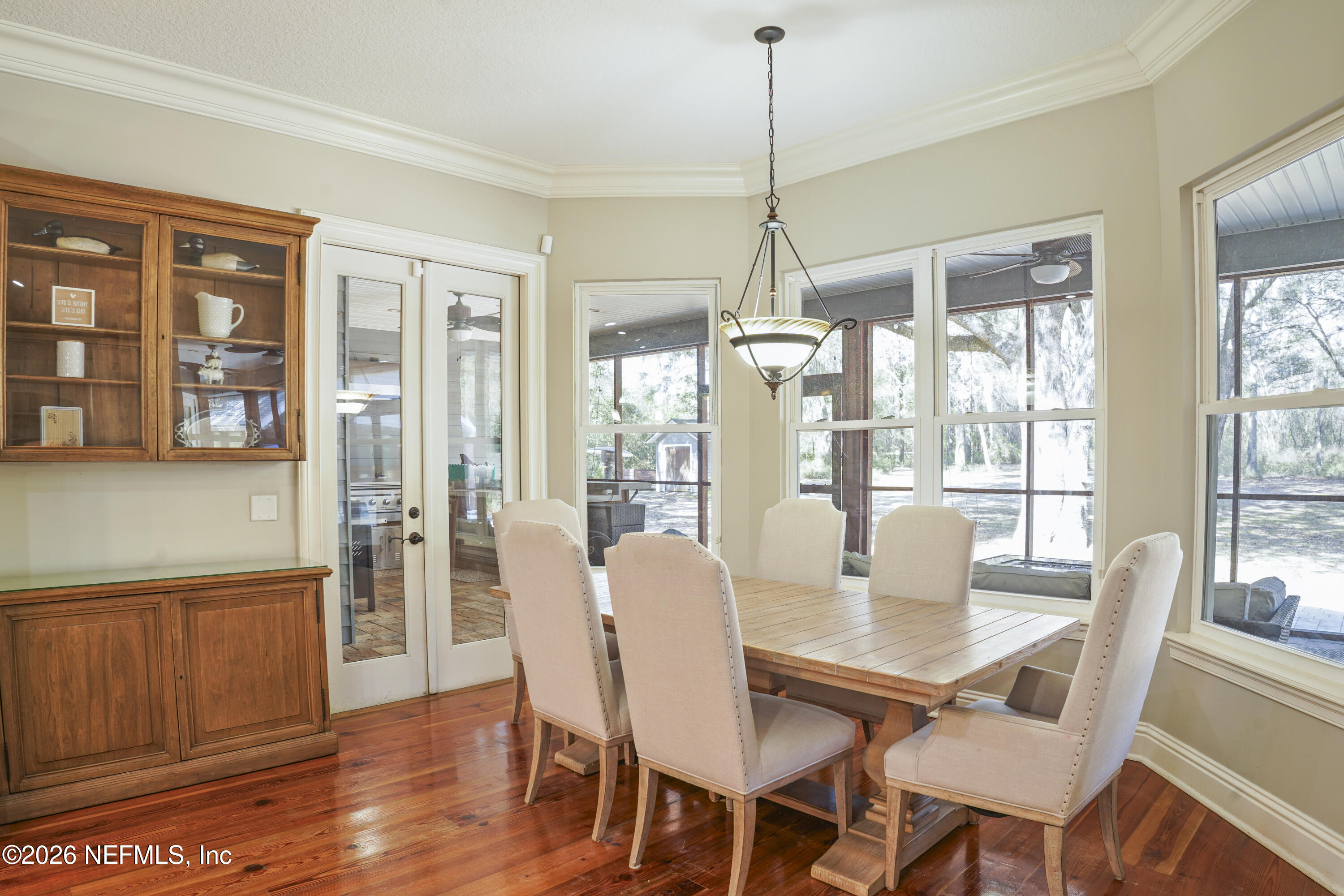 6153 Tim Crews Road Macclenny, FL 32063 - Photo 62 of 79 a view of a dining room with furniture window and wooden floor