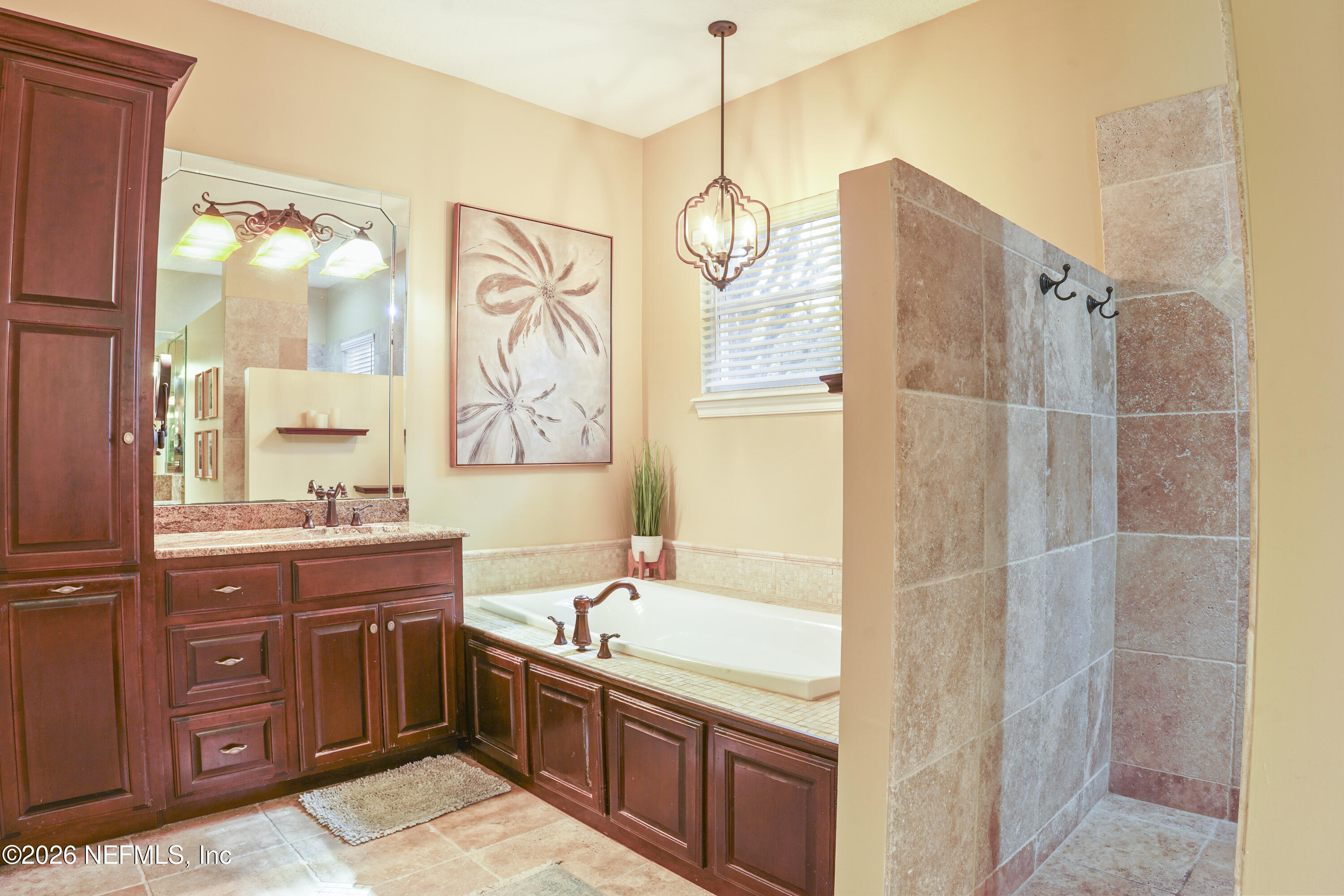 6153 Tim Crews Road Macclenny, FL 32063 - Photo 68 of 79 a bathroom with a tub sink and mirror