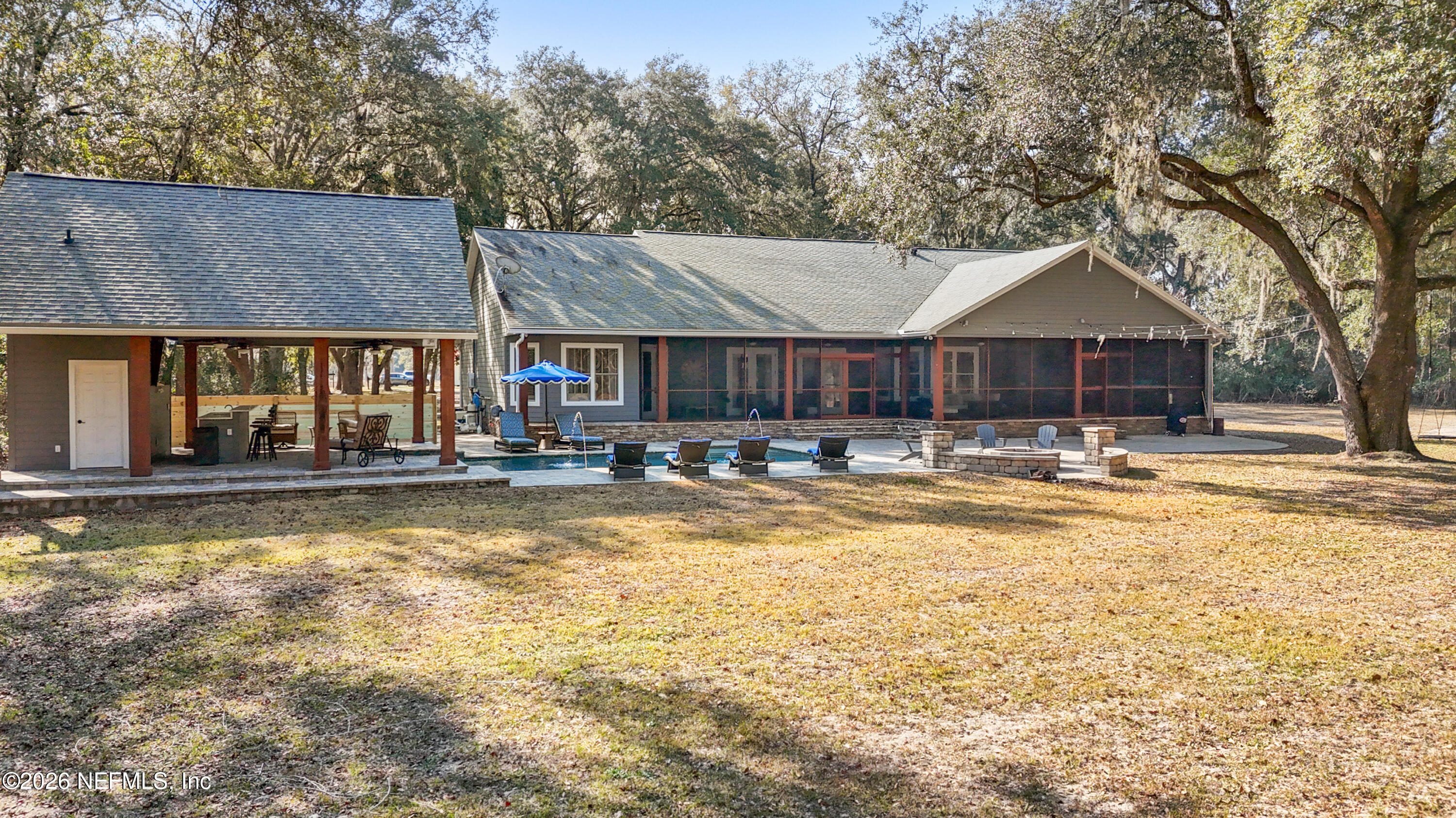 6153 Tim Crews Road Macclenny, FL 32063 - Photo 7 of 79 a view of swimming pool and trees in the background