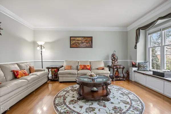 a view of a dining room with furniture a chandelier and wooden floor