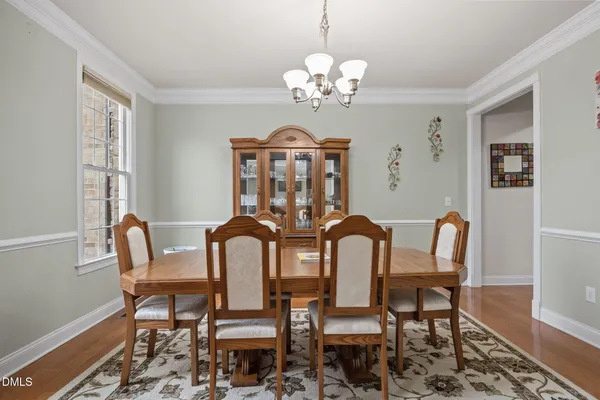 a view of a livingroom with wooden floor and stairs