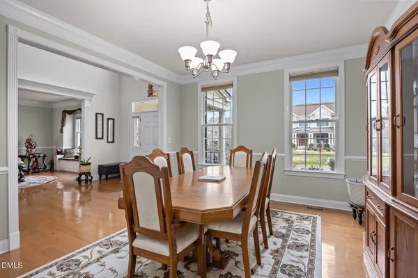 a kitchen with stainless steel appliances granite countertop wooden cabinets a sink and dishwasher a stove top oven with wooden floor