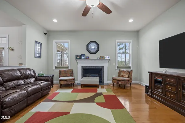 a kitchen with stainless steel appliances granite countertop a table chairs sink and cabinets