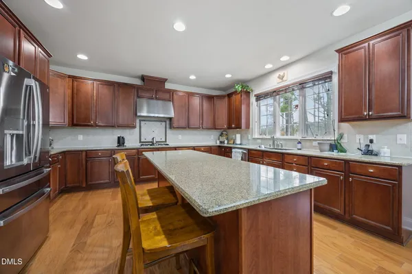 a bedroom with a bed chandelier and a window