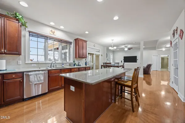 a large bed sitting in a bedroom next to a window and a mirror