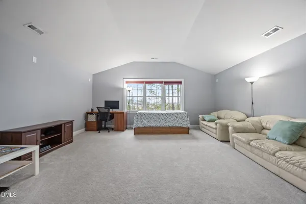 a view of walk in closet with clothes