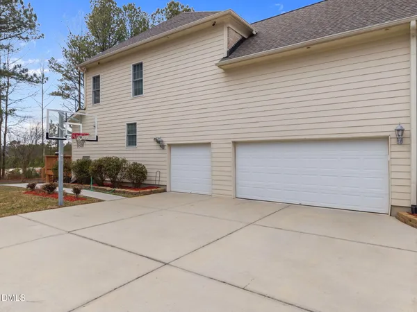 a view of a house with a yard and sitting area
