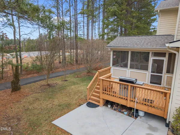 a view of a house with wooden fence and a porch