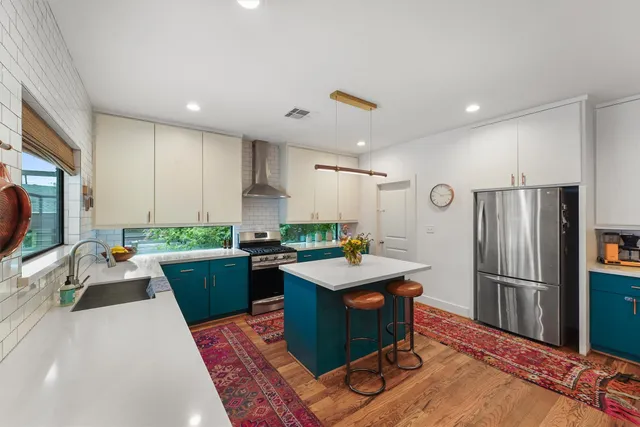 a kitchen with a refrigerator a stove top oven a sink dishwasher and wooden cabinets