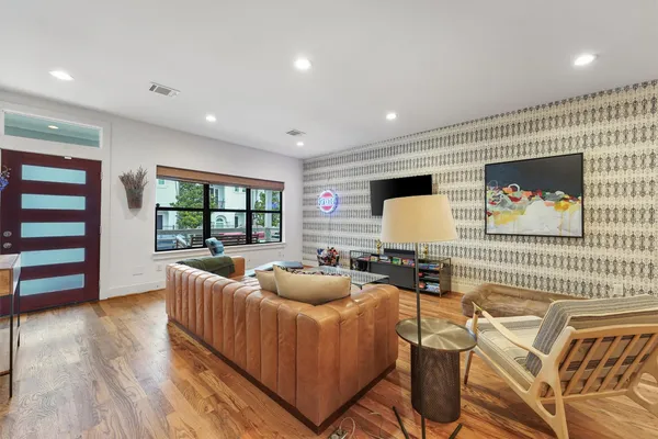 a living room with furniture and wooden floor