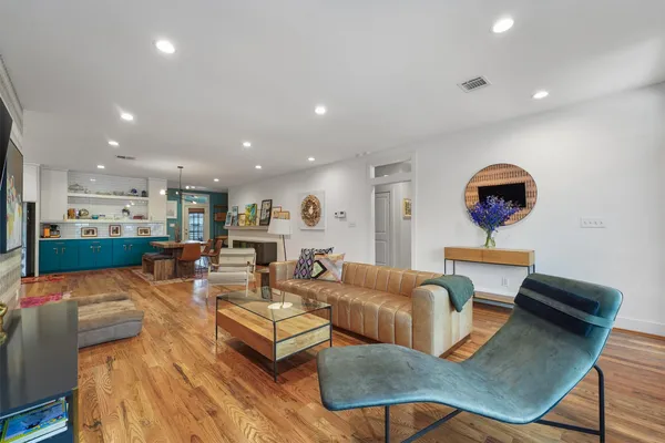 a living room with furniture and a floor to ceiling window