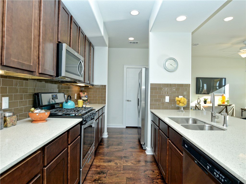 8944 Parker Ranch Circle, Unit A Austin, TX 78748 - Photo 1 of 1 a kitchen with stainless steel appliances a sink stove and cabinets