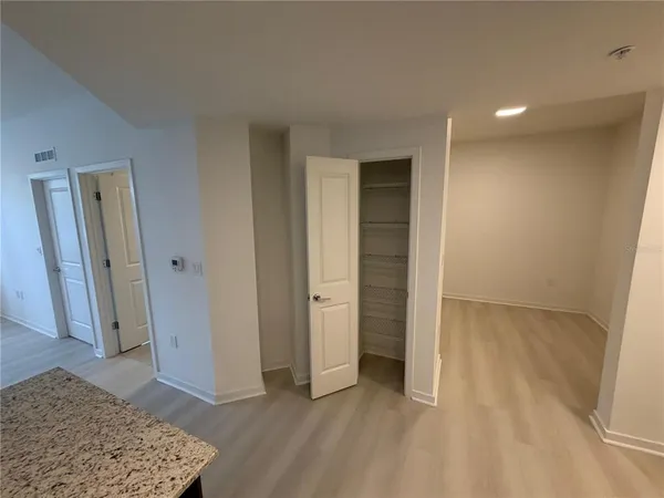 an empty room with closet and mirror