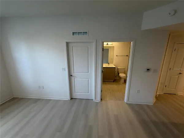 a view of hallway with wooden floor