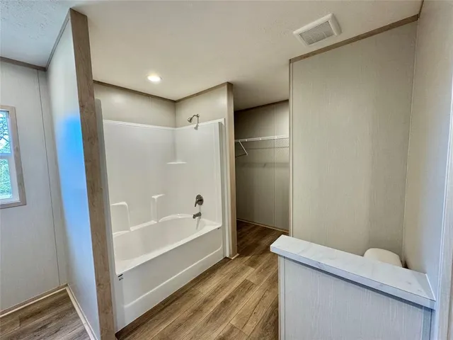 a spacious bathroom with a double vanity sink and a mirror