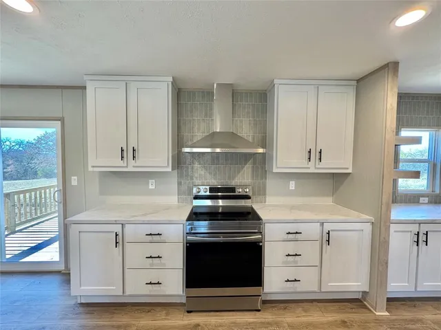a kitchen with granite countertop a stove and a cabinets