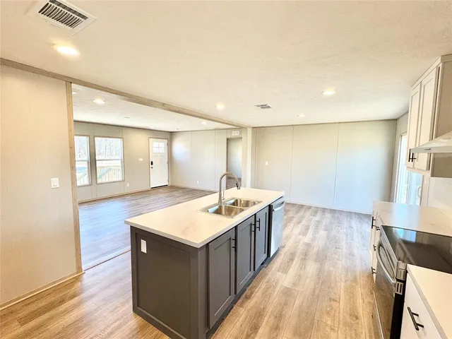 a kitchen with stainless steel appliances a refrigerator and a stove