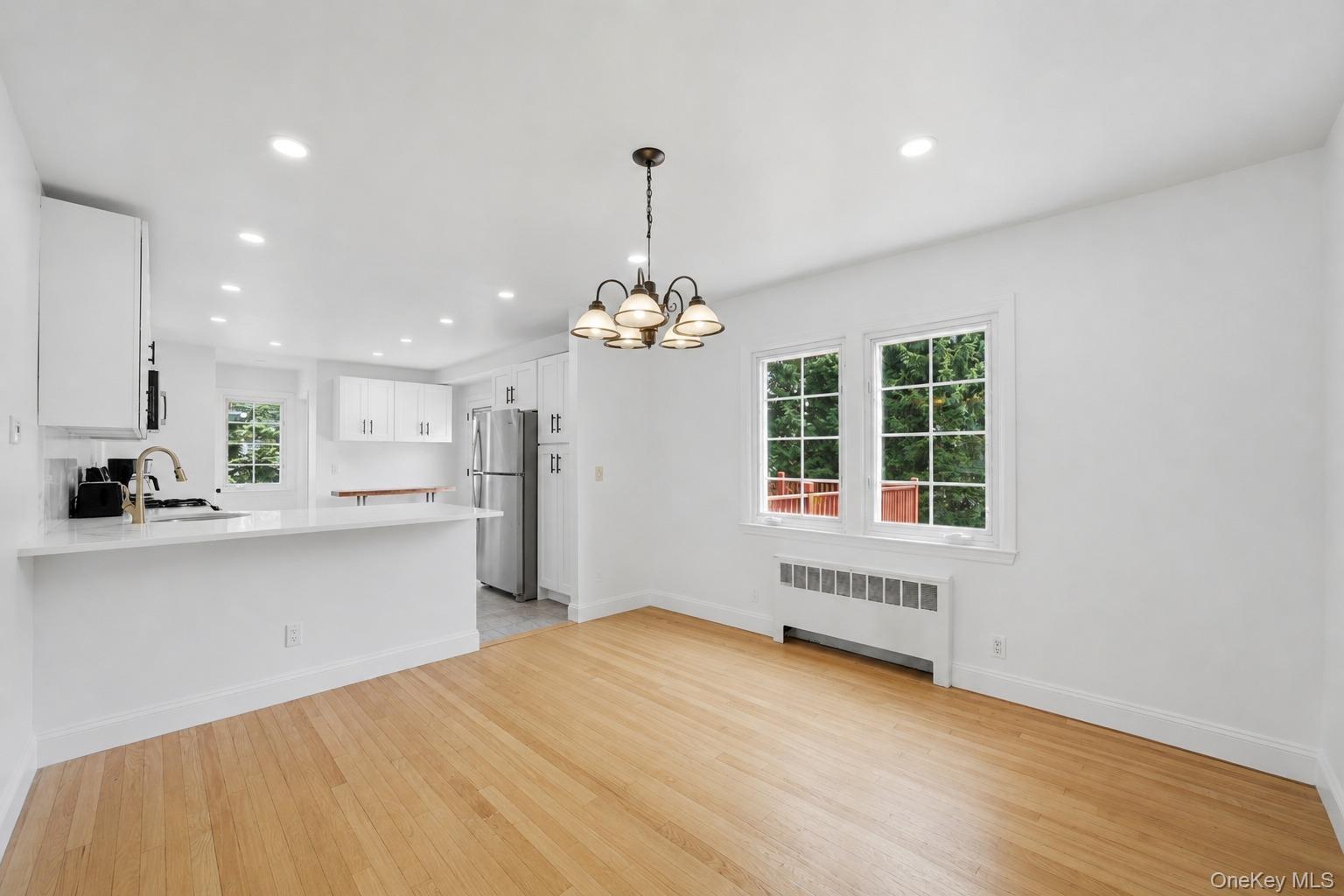 144 Bell Road Scarsdale, NY 10583 - Photo 10 of 49 Bright dining area featuring wood-finish flooring, a multi-pane window