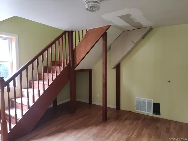 a view of an entryway with wooden floor