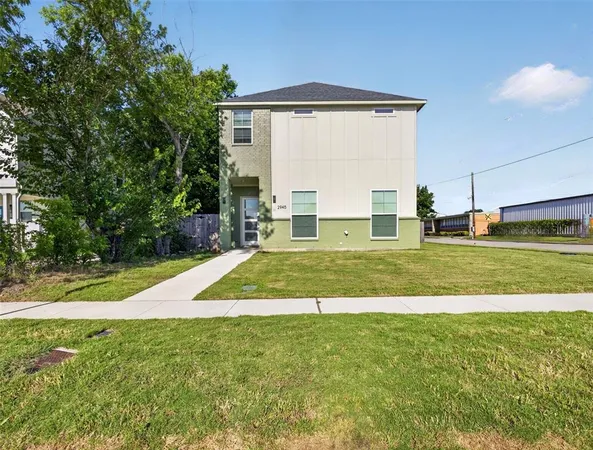 a view of a house with a yard and sitting area