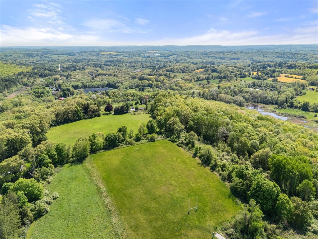0 Center Road Dudley, MA 01571 - Photo 3 of 12 an aerial view of residential houses with outdoor space and trees