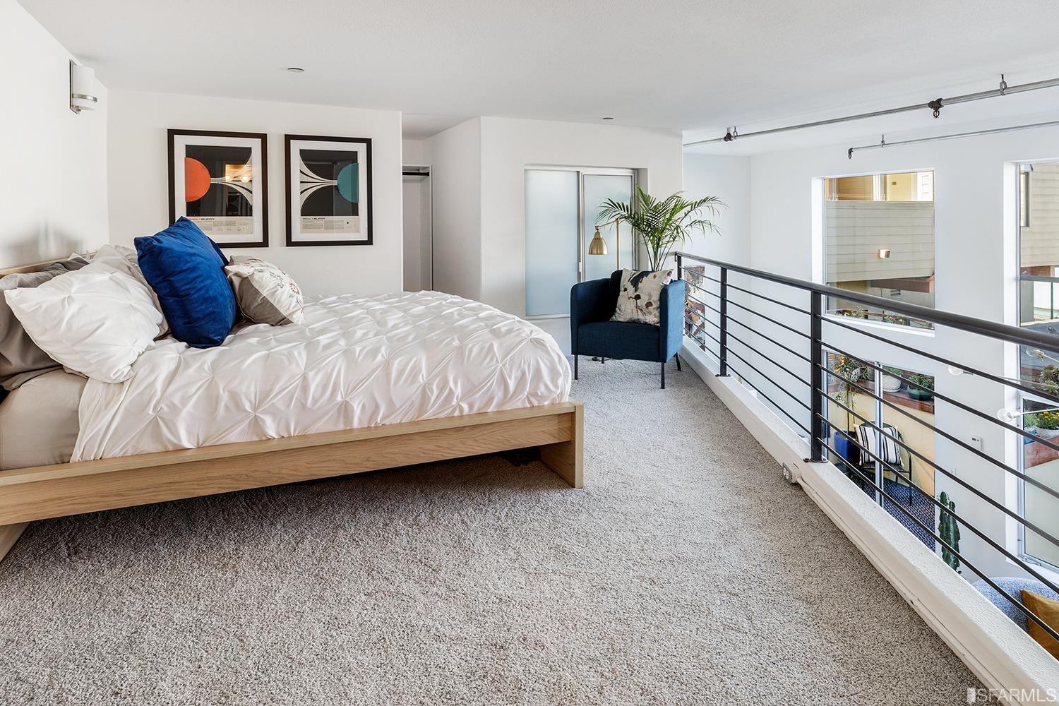 728 Alabama Street, Unit 205 San Francisco, CA 94110 - Photo 13 of 19 a bedroom with a bed and a painting on the wall