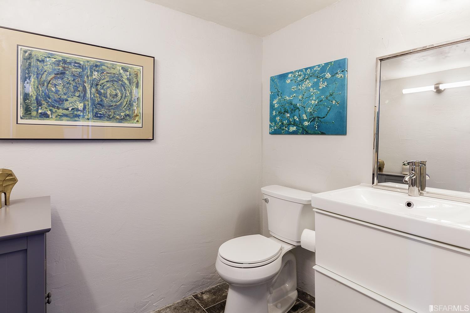 728 Alabama Street, Unit 205 San Francisco, CA 94110 - Photo 18 of 19 a white toilet sitting next to a bathroom sink