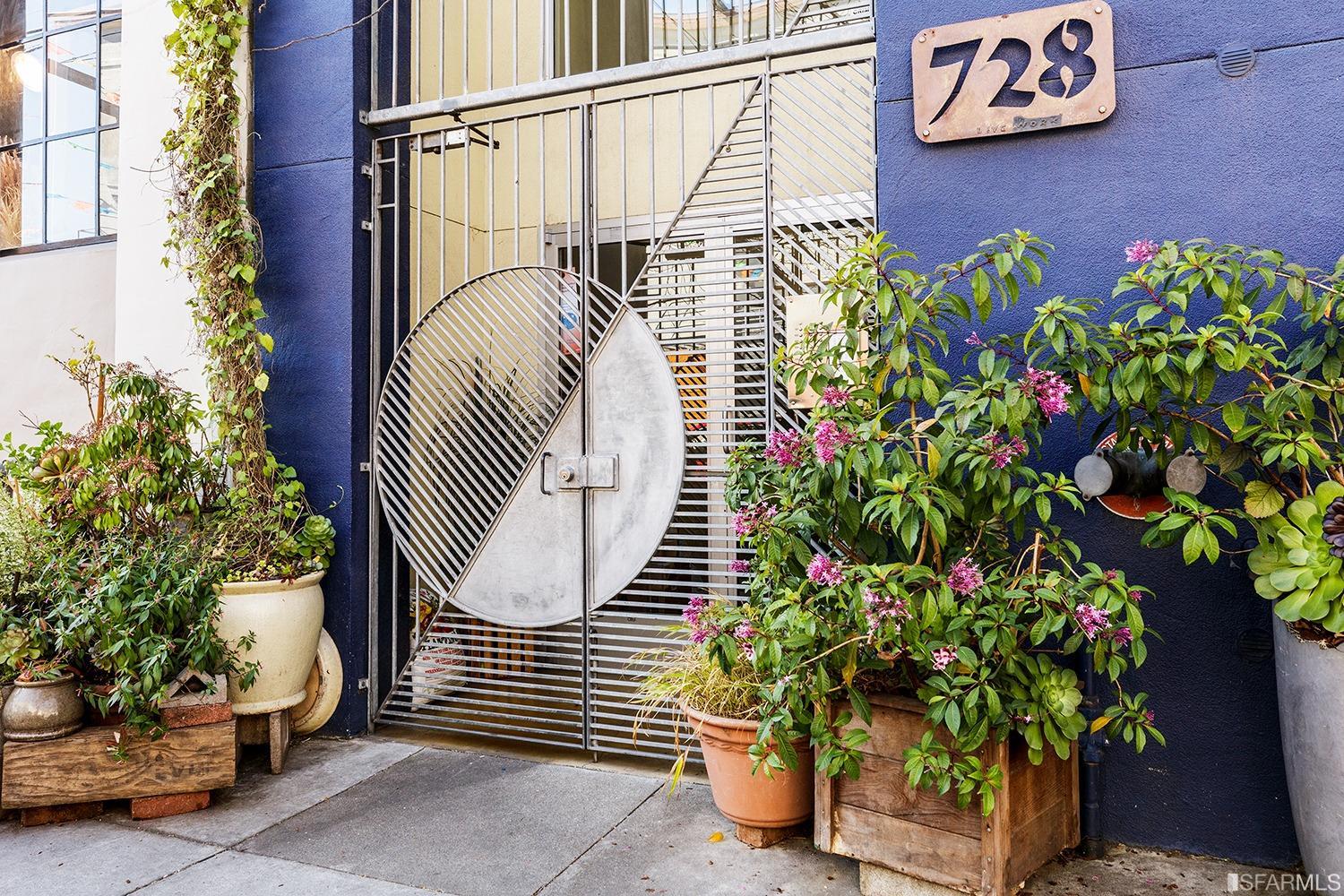 728 Alabama Street, Unit 205 San Francisco, CA 94110 - Photo 2 of 19 a view of a potted plant with a sign on the wall