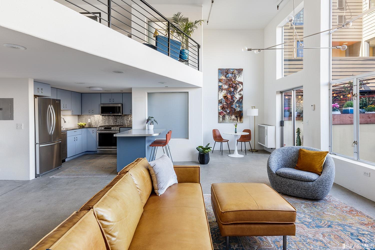 728 Alabama Street, Unit 205 San Francisco, CA 94110 - Photo 6 of 19 a living room with furniture a rug and kitchen view