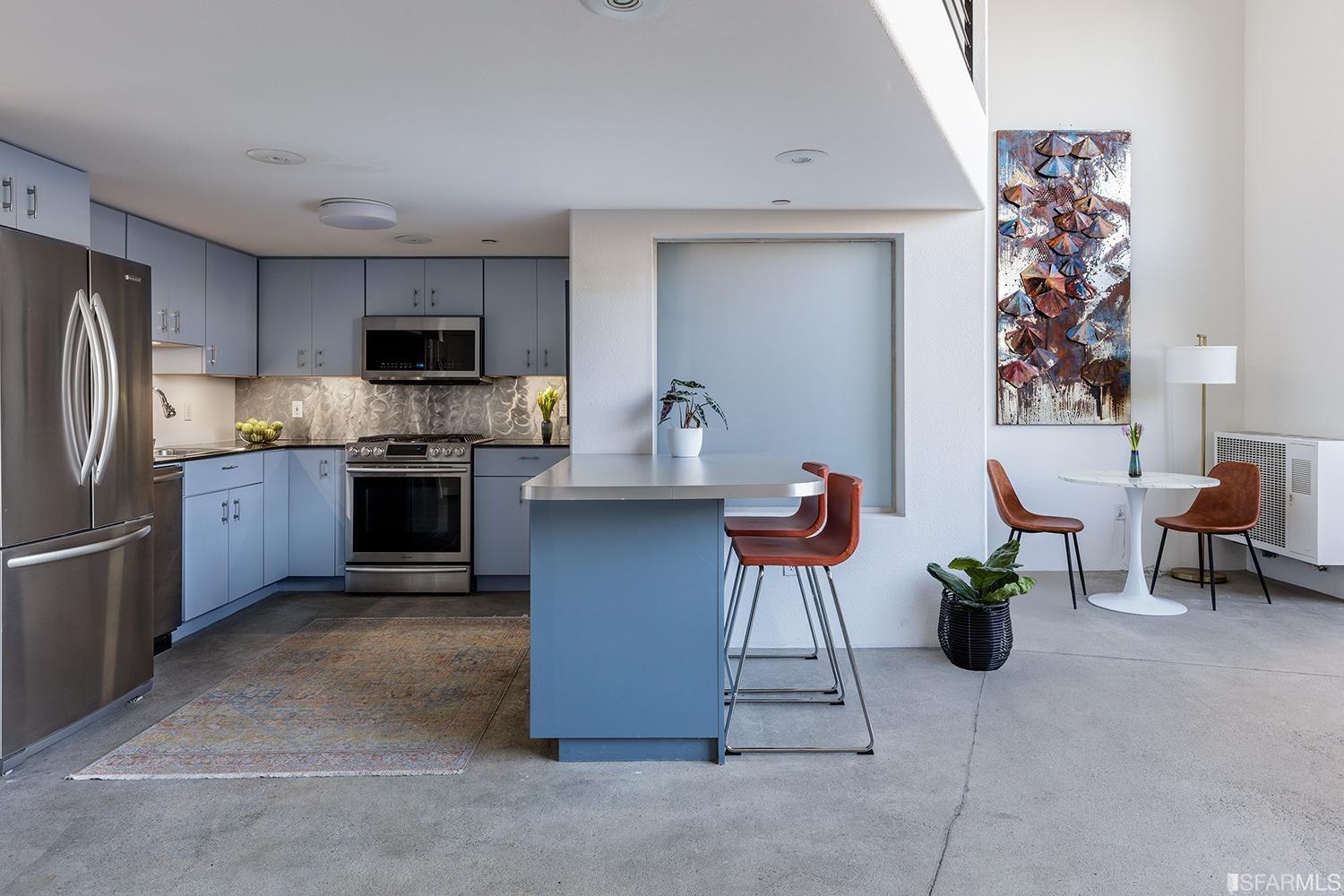 728 Alabama Street, Unit 205 San Francisco, CA 94110 - Photo 7 of 19 a kitchen with furniture a refrigerator and a view of living room