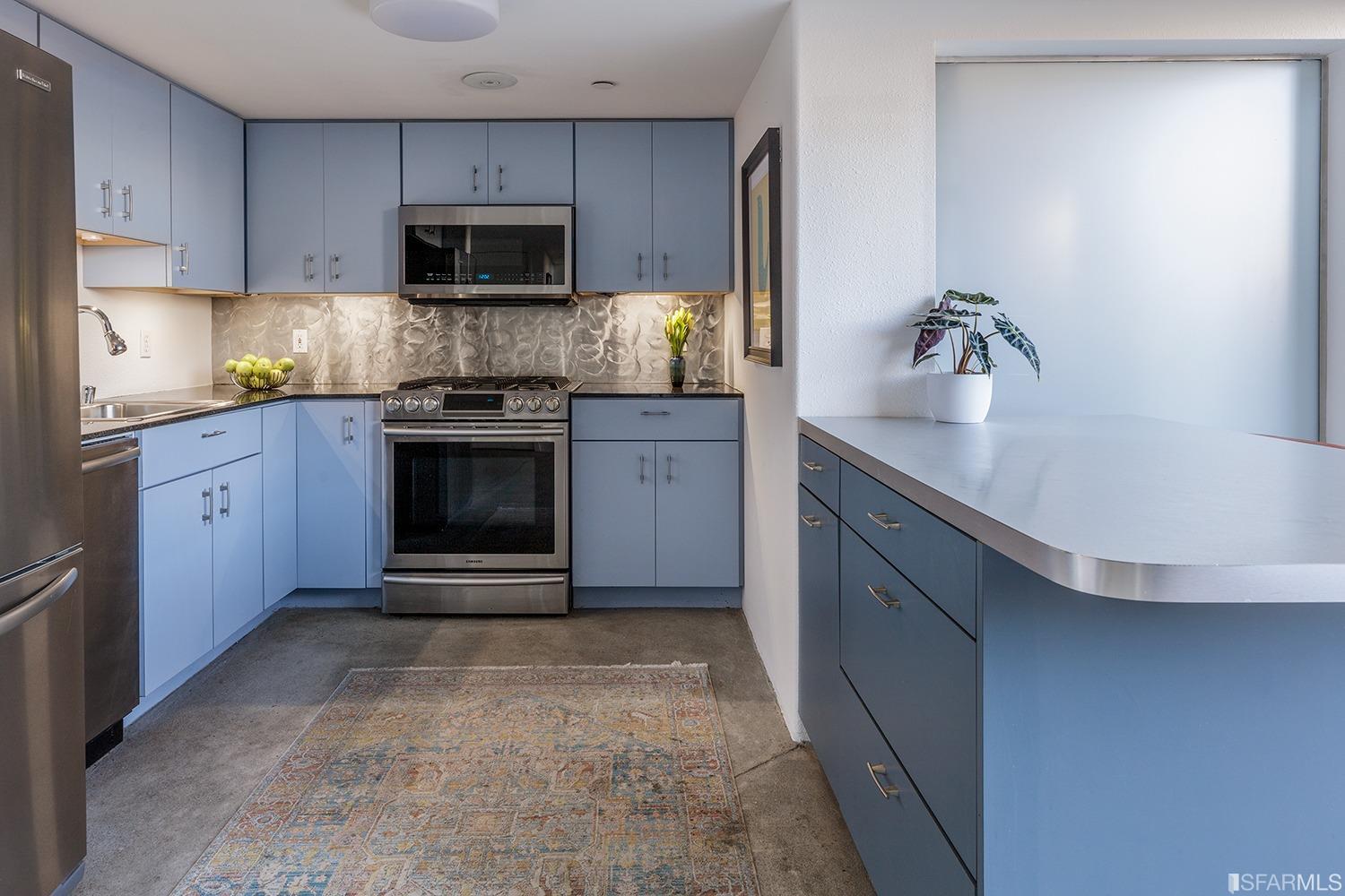 728 Alabama Street, Unit 205 San Francisco, CA 94110 - Photo 8 of 19 a kitchen with stainless steel appliances granite countertop a stove a sink and a microwave
