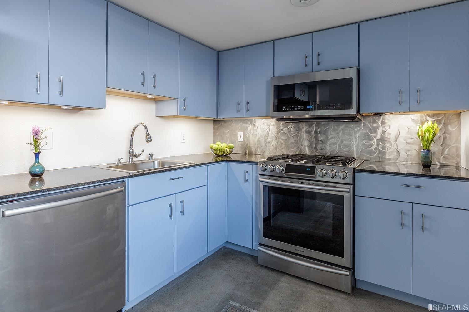 728 Alabama Street, Unit 205 San Francisco, CA 94110 - Photo 9 of 19 a kitchen with granite countertop white cabinets stainless steel appliances and sink