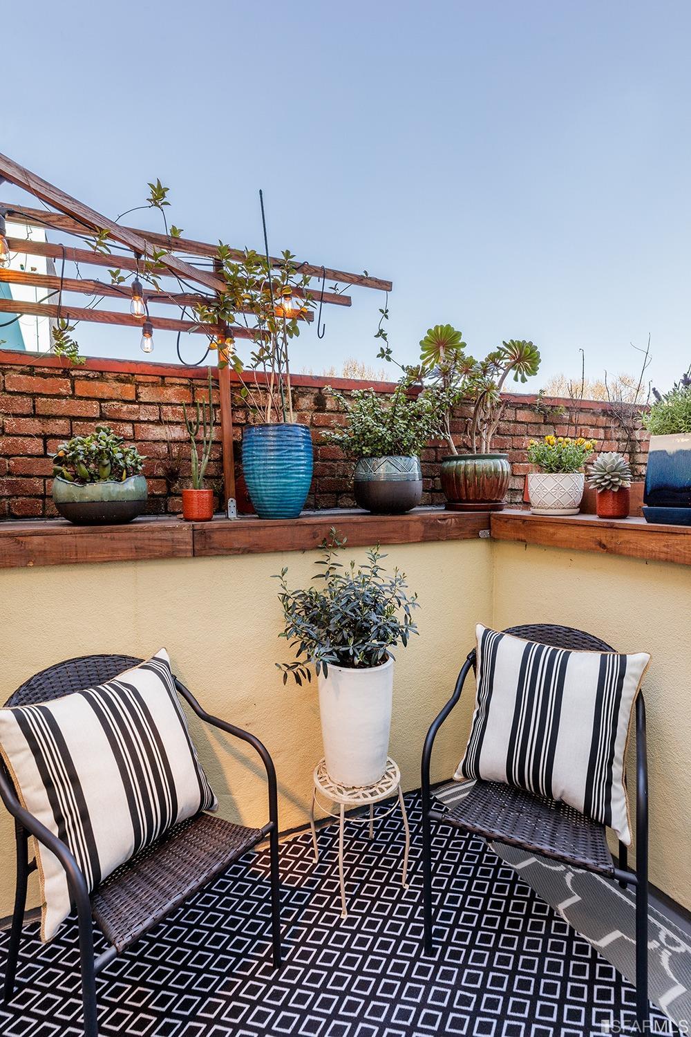 728 Alabama Street, Unit 205 San Francisco, CA 94110 - Photo 10 of 19 a balcony with furniture and water view