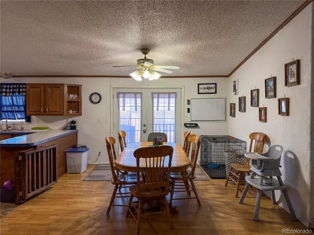 a dining room with furniture a chandelier and wooden floor