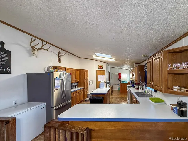 a view of a living room and kitchen