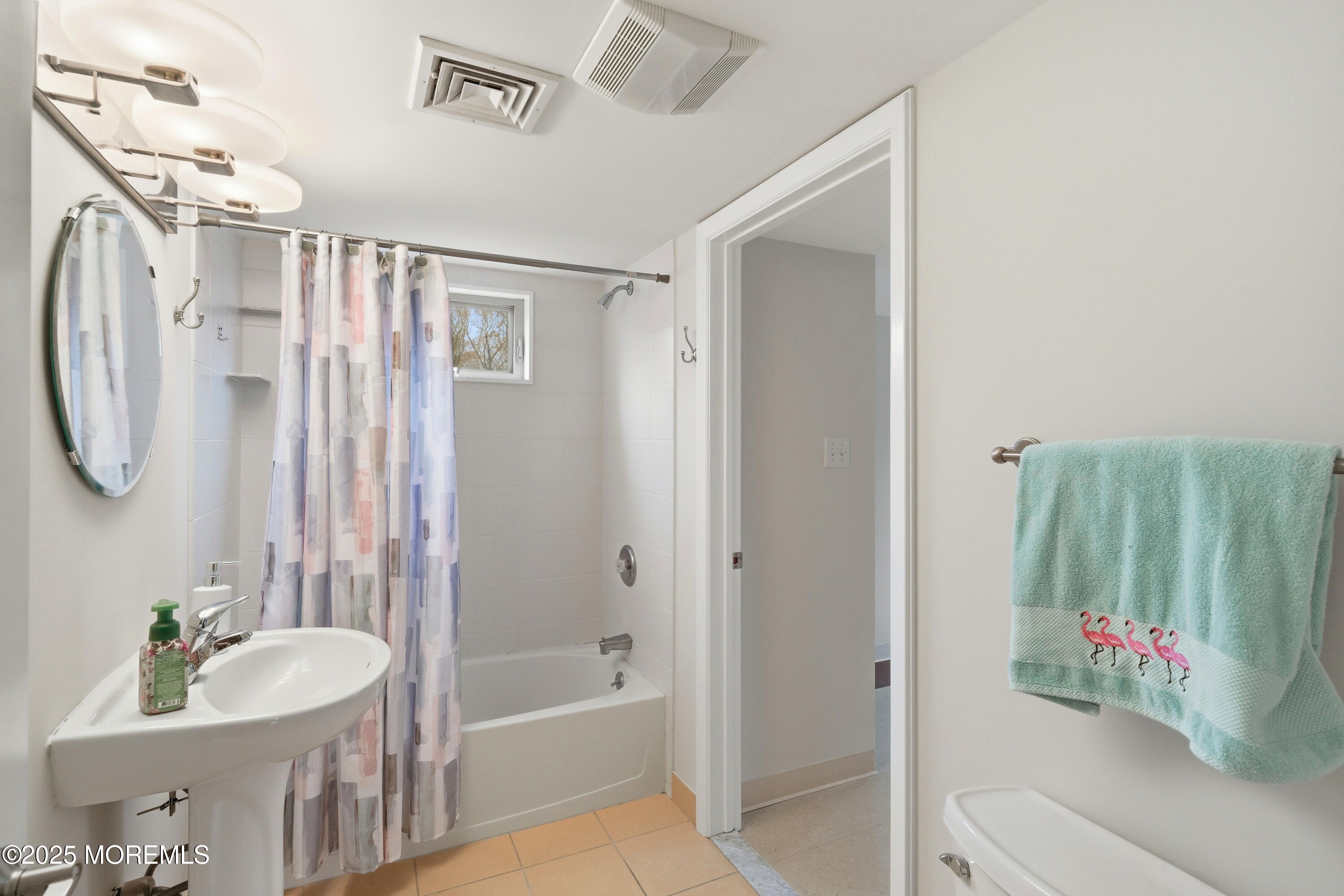400 Main Street, Unit 2 West Creek, NJ 08092 - Photo 12 of 22 a bathroom with a tub a sink and a mirror
