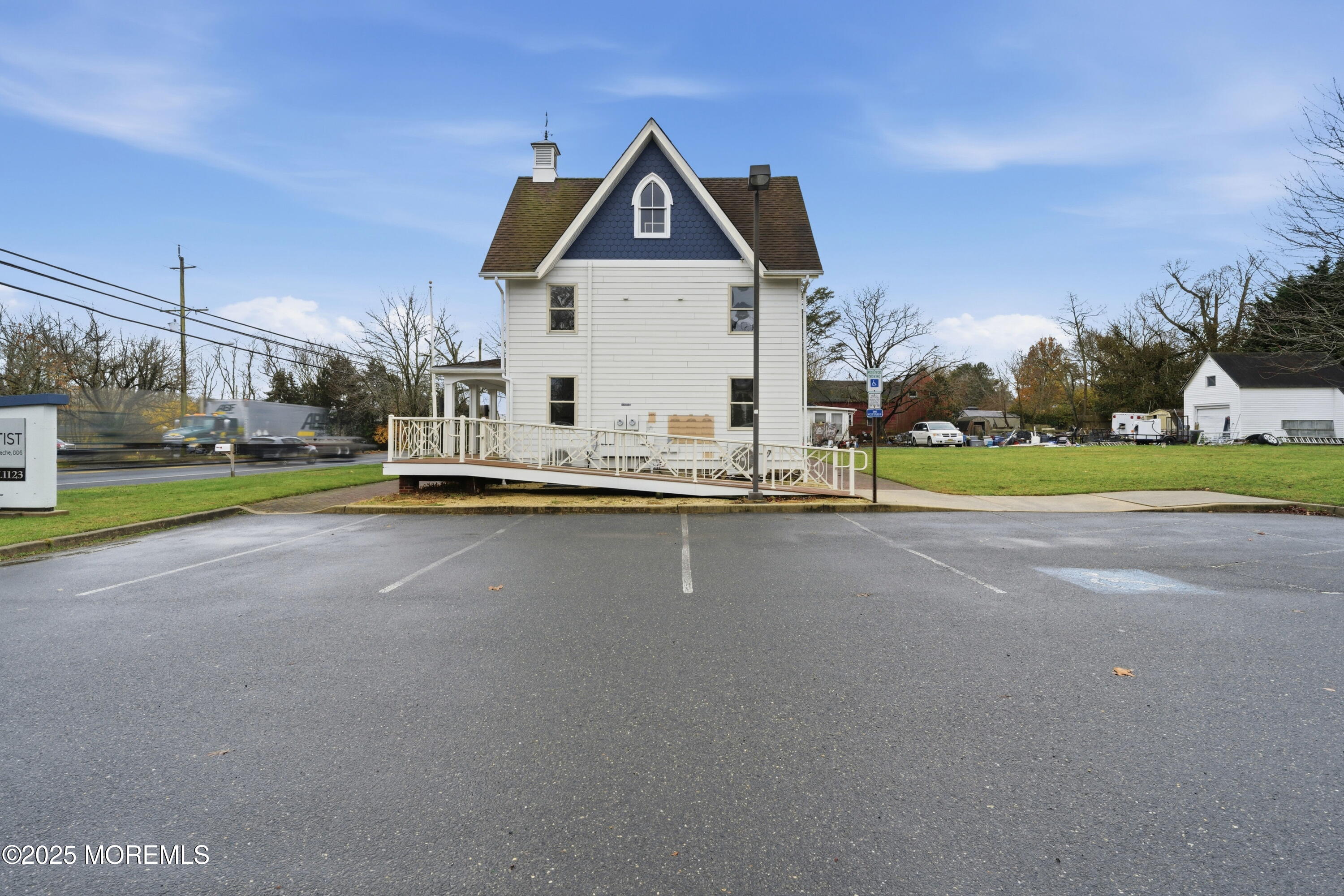 400 Main Street, Unit 2 West Creek, NJ 08092 - Photo 17 of 22 a front view of a house with a yard table and chairs