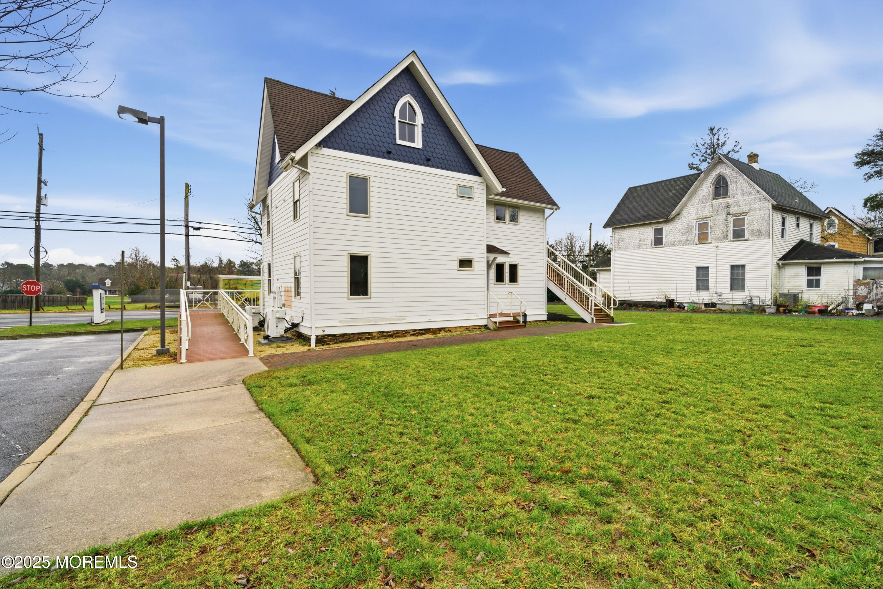400 Main Street, Unit 2 West Creek, NJ 08092 - Photo 20 of 22 a view of a white house next to a yard with big trees