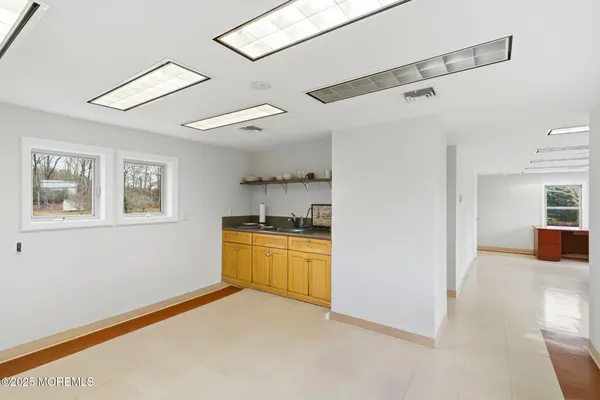 a view of a kitchen with a sink dishwasher and wooden floor