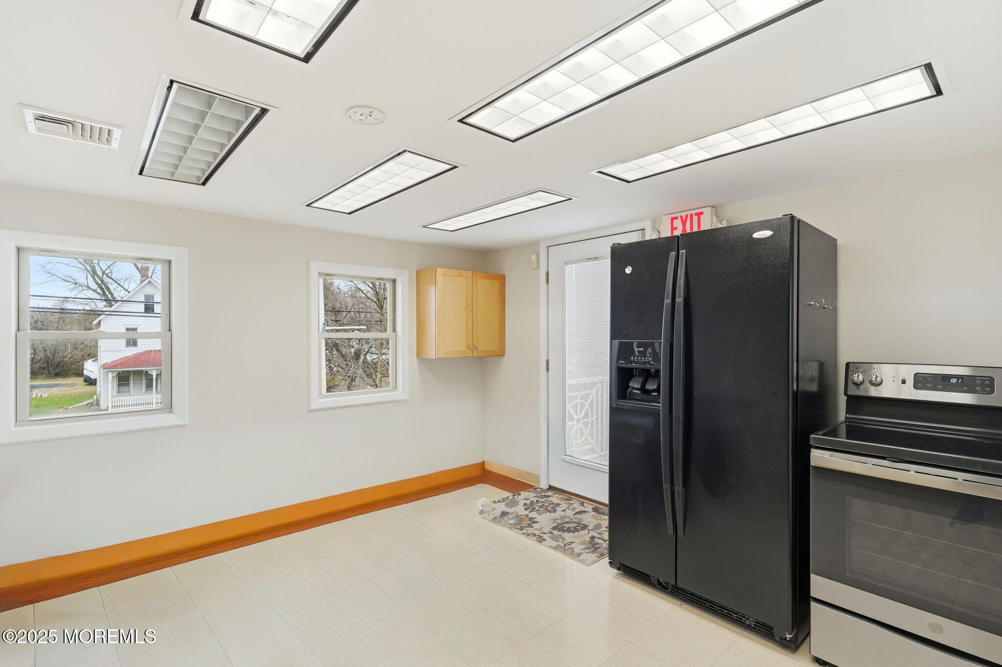 400 Main Street, Unit 2 West Creek, NJ 08092 - Photo 7 of 22 a kitchen with stainless steel appliances granite countertop a refrigerator and a stove