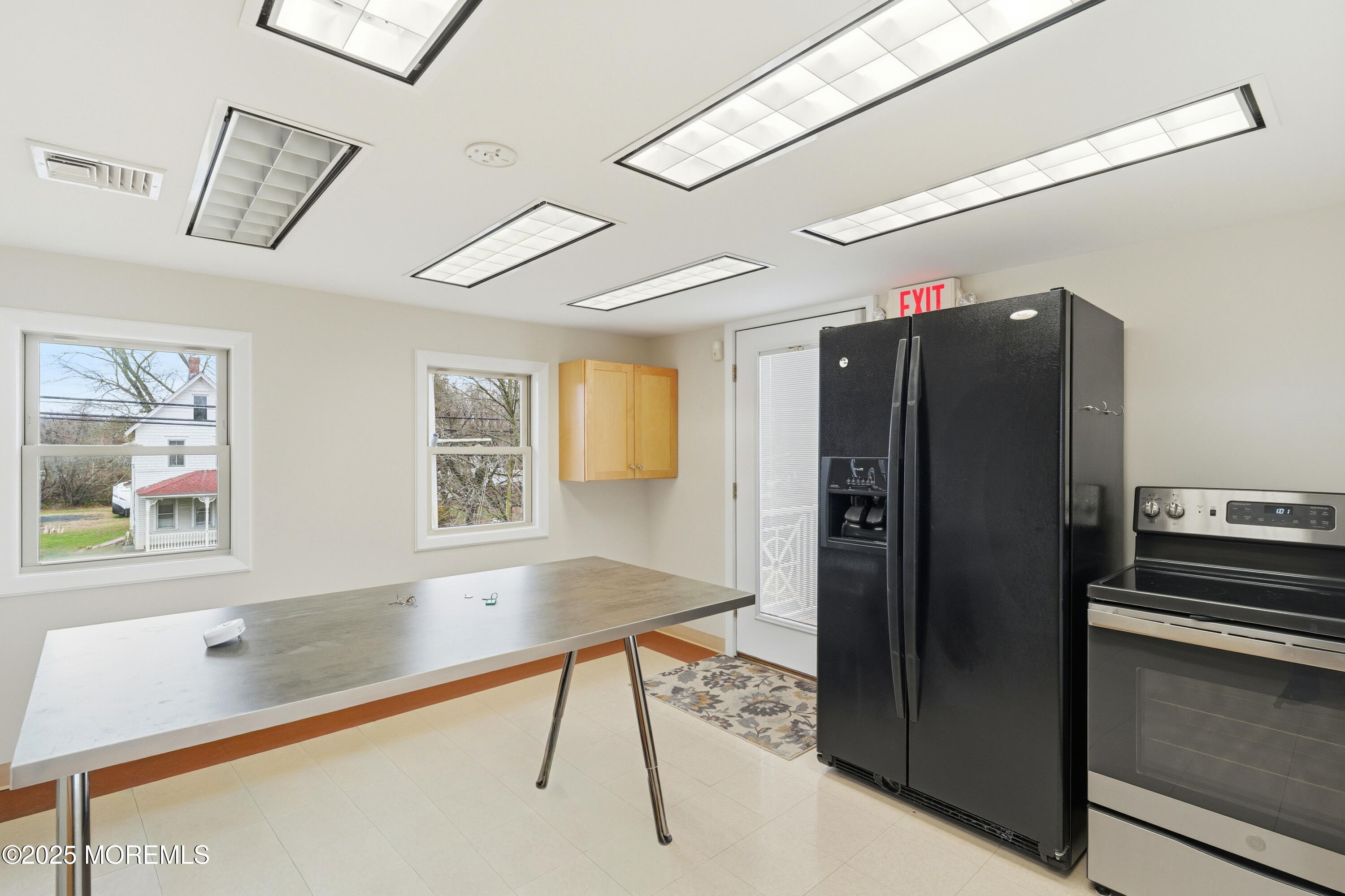 400 Main Street, Unit 2 West Creek, NJ 08092 - Photo 8 of 22 a kitchen with stainless steel appliances granite countertop a refrigerator and a stove top oven