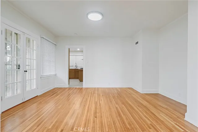 a kitchen with a refrigerator and white cabinets