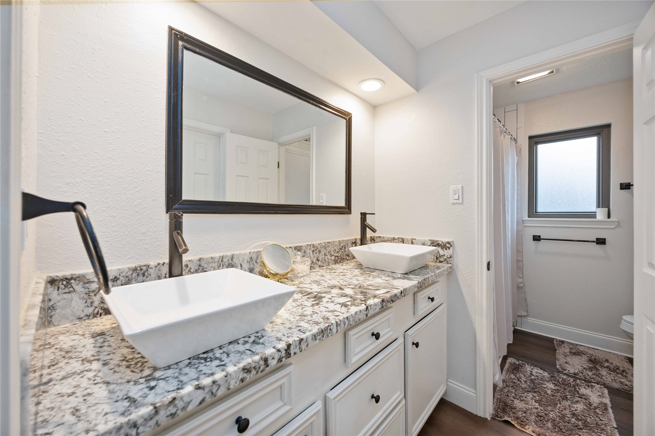 7310 Hickory Lane Baytown, TX 77521 - Photo 14 of 17 a bathroom with a granite countertop sink and a mirror