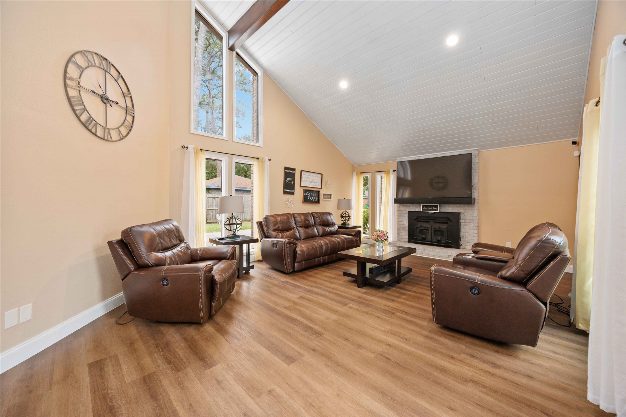 7310 Hickory Lane Baytown, TX 77521 - Photo 6 of 17 a living room with furniture a flat screen tv and a fireplace