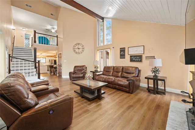 a living room with furniture and wooden floor