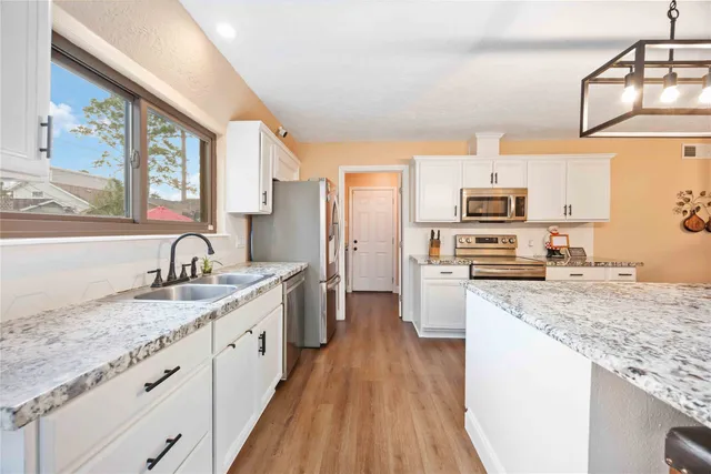a kitchen with a sink stove and refrigerator