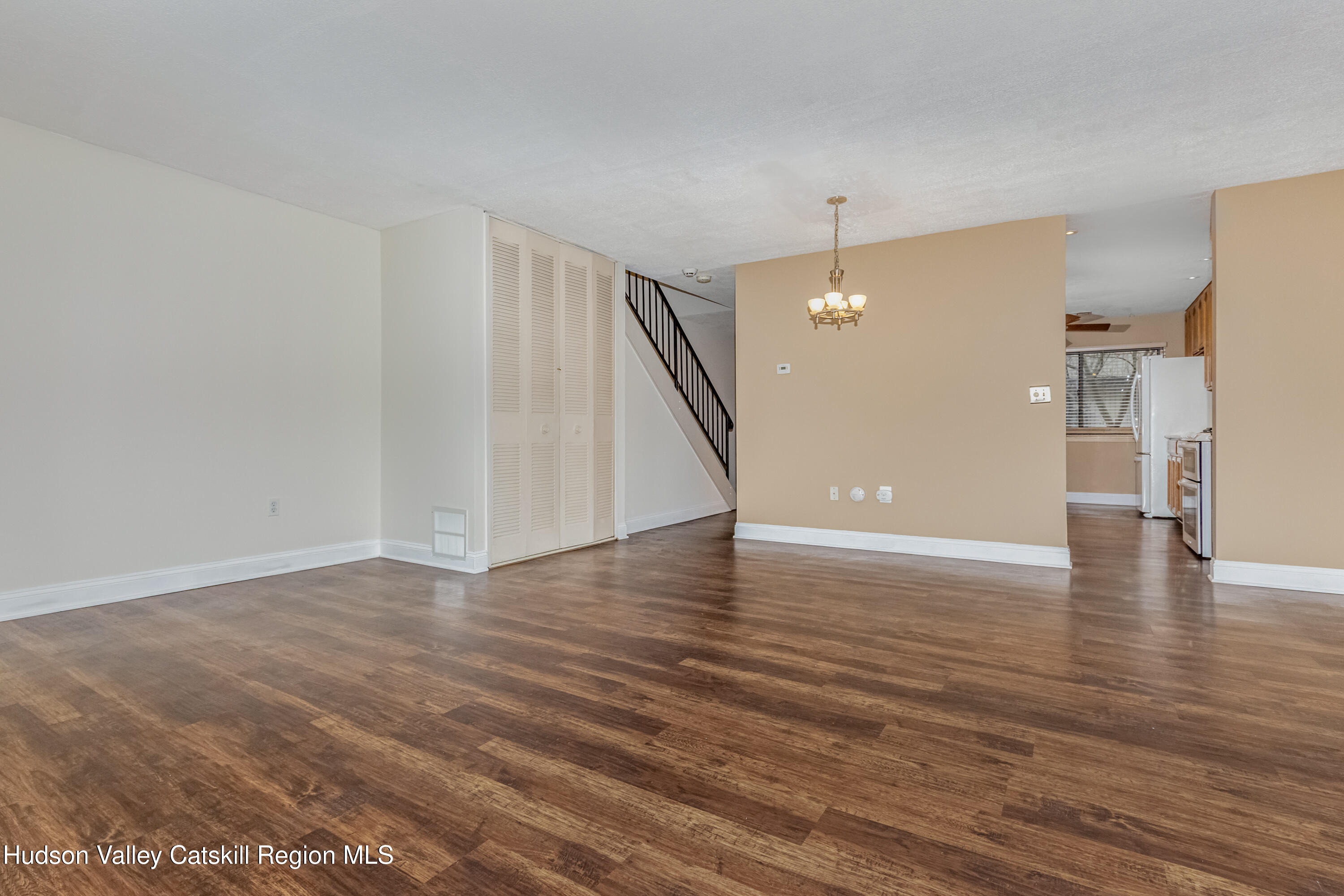 1907 Magnolia Walk Poughkeepsie, NY 12603 - Photo 12 of 36 a view of a livingroom with wooden floor and stairs