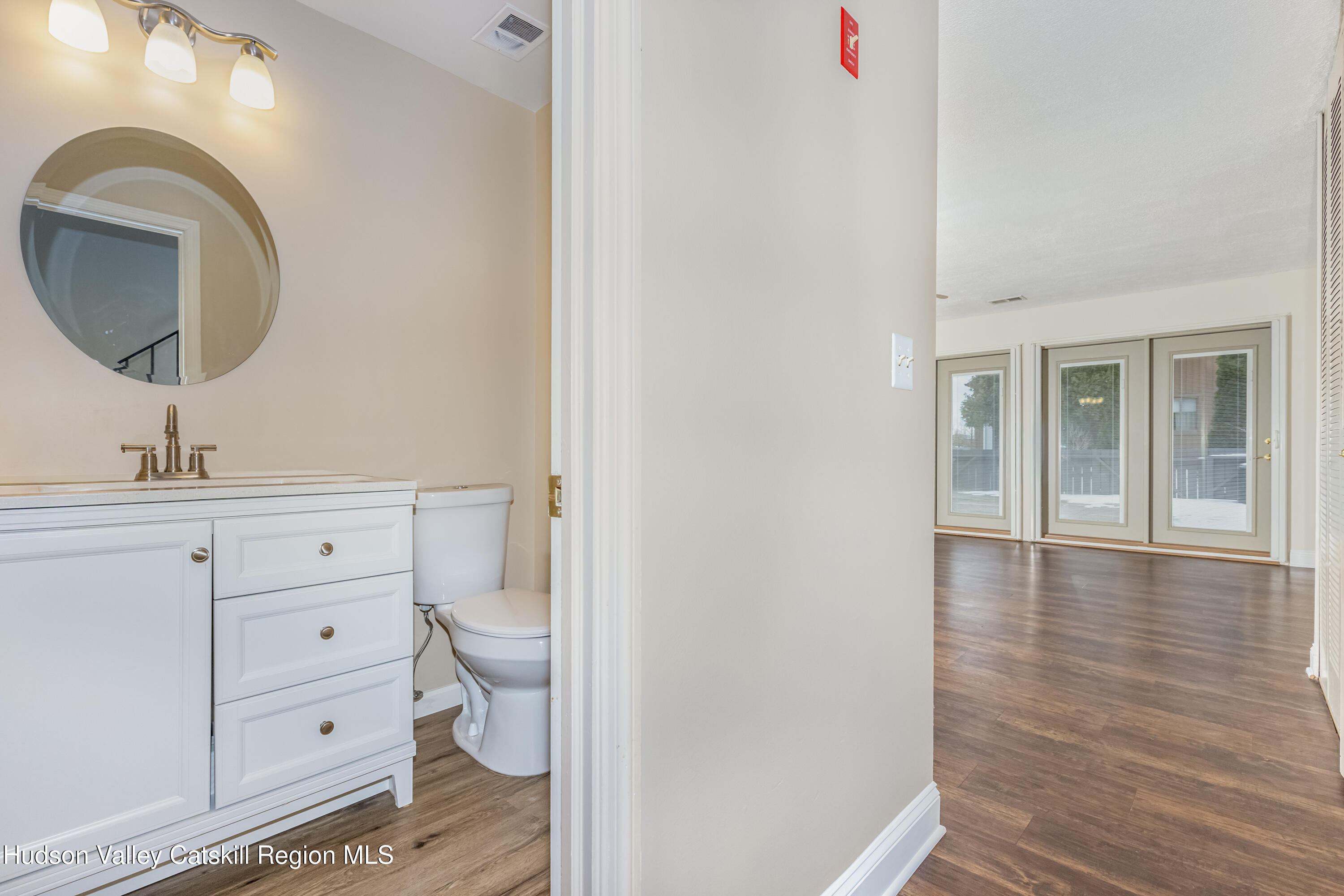1907 Magnolia Walk Poughkeepsie, NY 12603 - Photo 16 of 36 a bathroom with a toilet a sink and a mirror